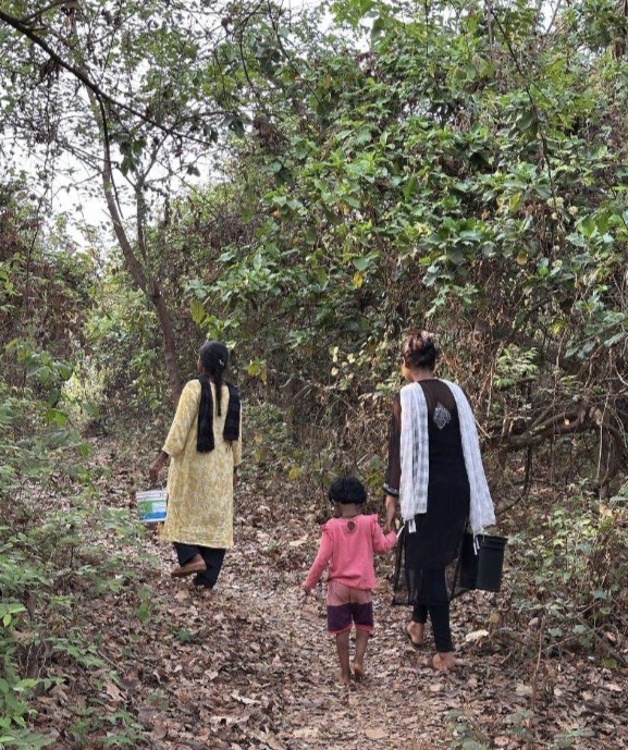 Walking to the tribal community with supplies